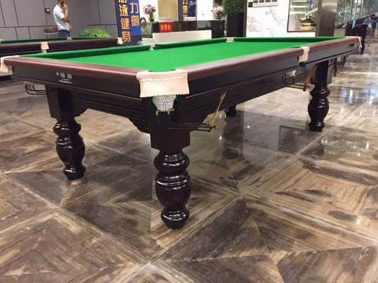 Snooker table with green felt surface on a tiled floor