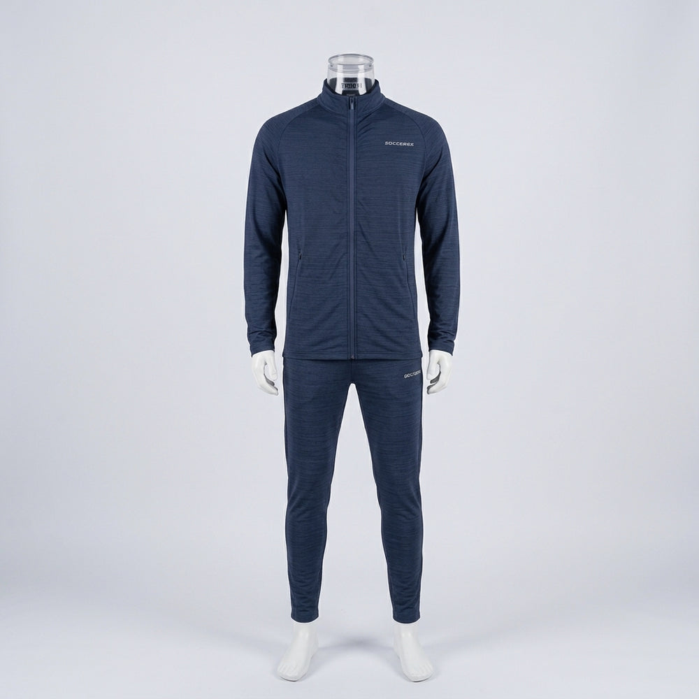 A dark navy blue athletic tracksuit displayed on a mannequin against a light gray studio background. The set includes a long-sleeve zip-up jacket with a small white logo on the left chest and matching slim-fit pants.