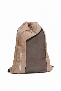 A tan and black drawstring backpack with a mesh front panel and vertical 'SOCCERAX' branding, shown worn over a purple shirt.