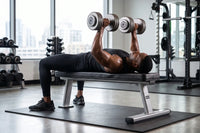 muscular man using the flat bench