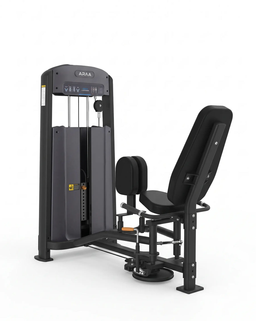 An hip abductor machine gym machine in black and dark gray, shown from a three-quarter angle on a solid white background.