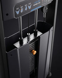 Close-up detail of a dark gray hip adbductor machine showing the pulley system, weight stack, and control panel with blue text and icons.